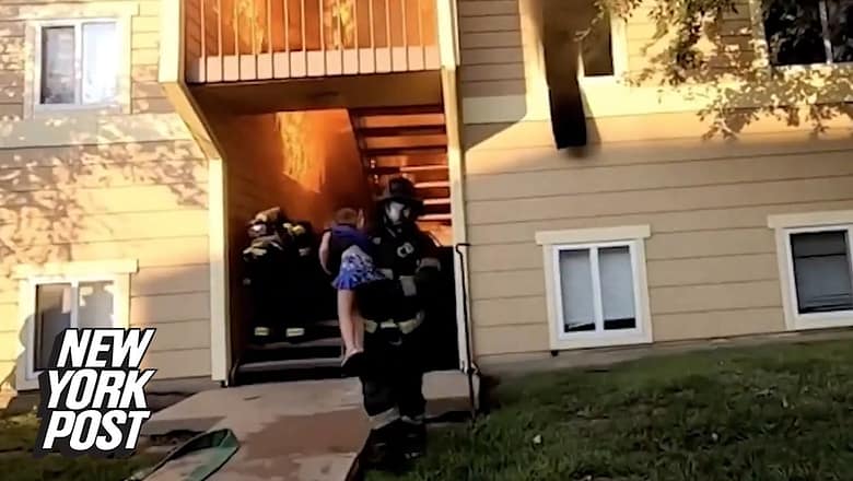 Hero Kansas firefighter caught on video rescuing little girl from burning building | New York Post