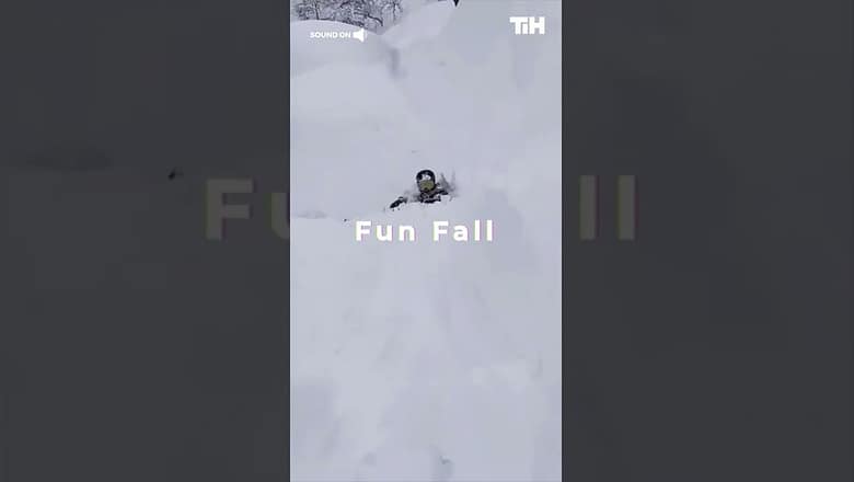 Person Falls Into Snow After Skiing off Incline