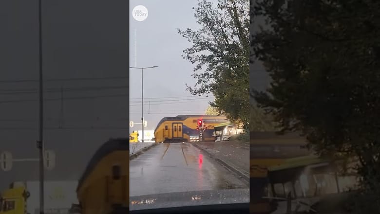 Passenger train collides with an empty bus, splitting it in half | USA TODAY #Shorts