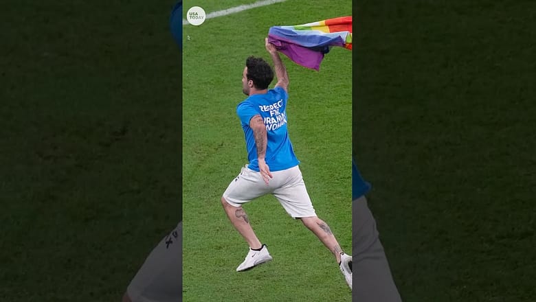 Protester carrying rainbow flag runs onto field at World Cup | USA TODAY #Shorts