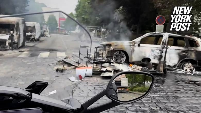 Local surveys burned vehicles in West Paris suburb following mass riots | New York Post