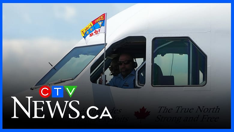 Pilot holds up standard after King Charles and Queen Camilla land in Ottawa